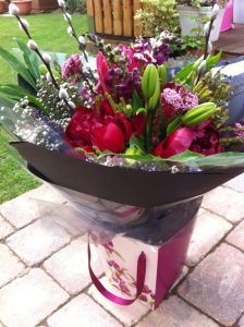Hand tied bouquet with pink peonies, lilies and pussy willow