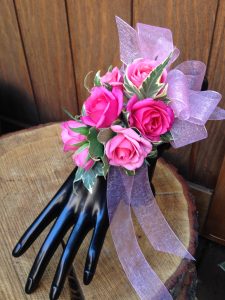 Miniature pink rise and ribbon wrist corsage