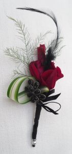 Red rose and black feather buttonhole